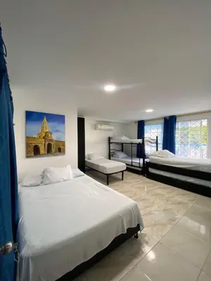 a bedroom with two beds and a large window at Hotel Blue Diamond House in Cartagena de Indias