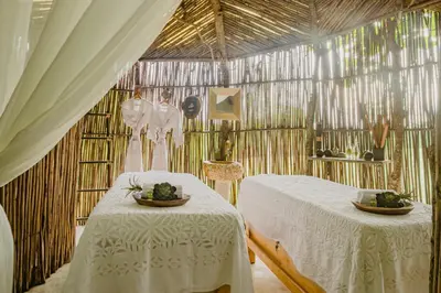 a room with two beds in a room with curtains at Éteka Slow Beach Hotel Adults Only in Cartagena de Indias