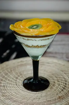 a martini with a yellow flower on a table at Éteka Slow Beach Hotel Adults Only in Cartagena de Indias