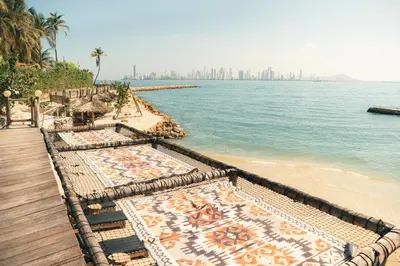a beach with a view of the dubai skyline at Éteka Slow Beach Hotel Adults Only in Cartagena de Indias