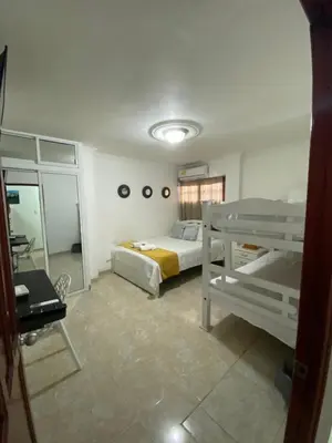 a bedroom with two bunk beds and a mirror at CASA PACHITA Getsemani in Cartagena de Indias