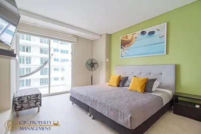 a bedroom with a bed and a large window at Martinique Cartagena, Beautiful 1 & 2 Bedroom Apartments in Cartagena de Indias