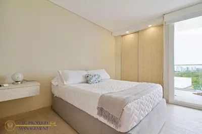 a bedroom with a bed and a large window at Martinique Cartagena, Beautiful 1 & 2 Bedroom Apartments in Cartagena de Indias