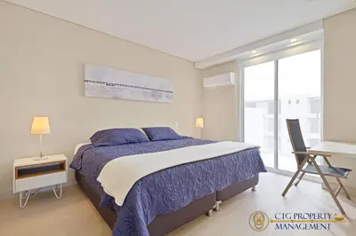 a bedroom with a bed and a desk and a window at Martinique Cartagena, Beautiful 1 & 2 Bedroom Apartments in Cartagena de Indias