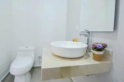 a bathroom with a sink and a toilet at Hotel OR Suites in Barranquilla
