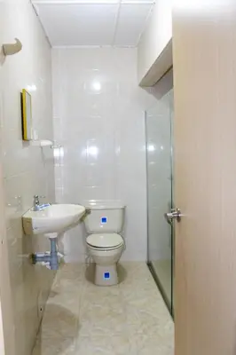 a bathroom with a toilet and a sink and a shower at Hotel Poblado Suite in Barranquilla
