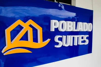 a blue and white sign with the nissan logo on it at Hotel Poblado Suite in Barranquilla