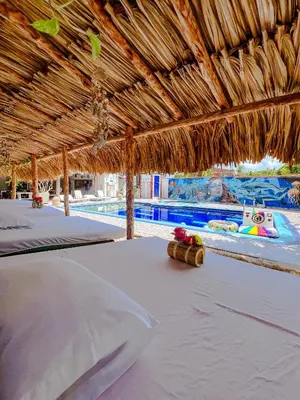 a resort with two beds and a swimming pool at Marazao Beach Hotel & Spa in Tierra Bomba