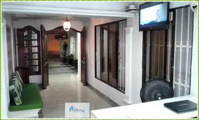a living room with a television on a wall at HOTEL CASA GARCES in Cartagena de Indias