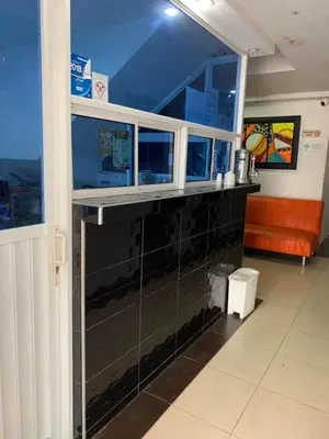 a room with a counter and a window in a building at Hotel Torres del Parque No1 in Soledad