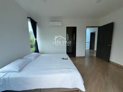 a bedroom with a large bed and a large window at VILLA MANDALAY in Santa Veronica