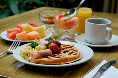 a table topped with plates of breakfast foods and drinks at Howard Johnson by Wyndham Barranquilla Versalles in Barranquilla