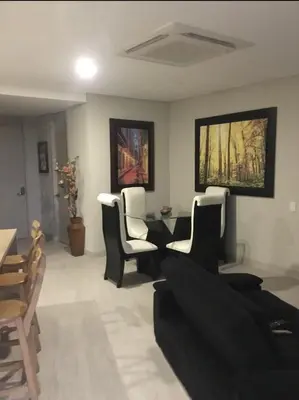 a living room with black and white chairs and a table at Martinique1621 in Cartagena de Indias