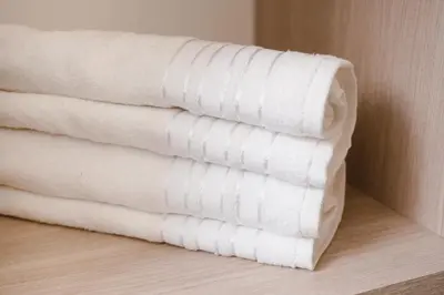a stack of white towels in a room at Casa Franco Hotel in Cartagena de Indias