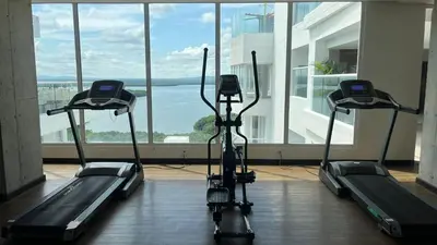 a gym with three exercise bikes in front of a window at Spiaggia Morros Direct Beach Access in Cartagena de Indias