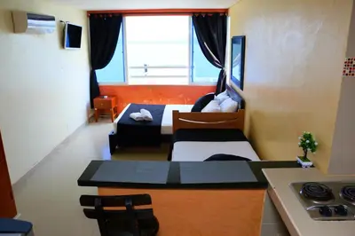 a room with a kitchen and a living room at Loft sea view 19C air and wifi in Cartagena de Indias