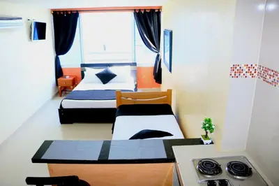 a small room with two beds and a kitchen at Loft sea view 19C air and wifi in Cartagena de Indias