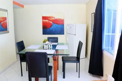 a dining room with a table and chairs and a refrigerator at Sea View Apartment 1-19C Air Wifi in Cartagena de Indias
