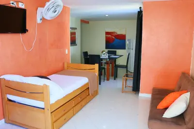 a bedroom with a bed and a living room at Sea View Apartment 1-19C Air Wifi in Cartagena de Indias