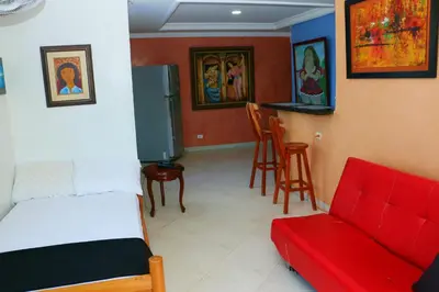 a room with a bed and a couch and chairs at Sea View Apartment 1-11C air wifi in Cartagena de Indias