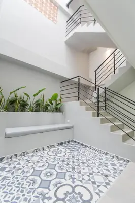 a staircase with a tiled floor with plants at Stanza Hotel Sincelejo in Sincelejo