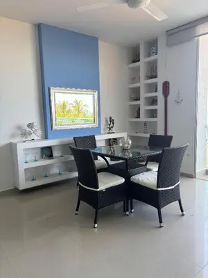 a dining room with a glass table and chairs at Mágico Apartamento Frente al Mar 3 Habitaciones PV21 in Coveñitas