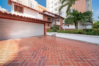 a brick driveway in front of a house with a garage at Villa Santos Apartaestudios in Barranquilla