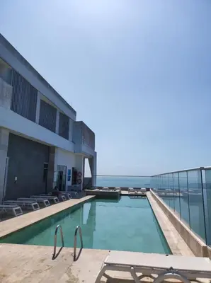 a swimming pool on the roof of a building at Apartamento Frente al Mar in Cartagena de Indias