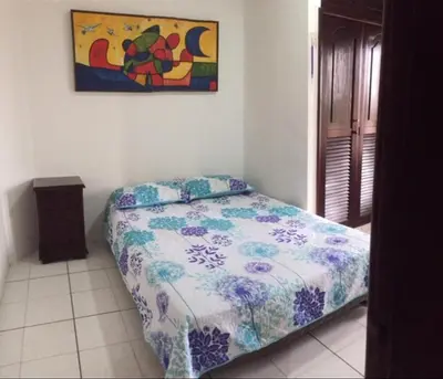 a bedroom with a bed and a painting on the wall at Cartagena Escape Plaza in Cartagena de Indias