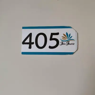 a sign with the number on a wall at Apartahotel Isla Fuerte Piso 4 in Cartagena de Indias