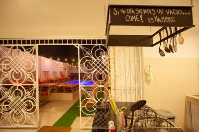 a kitchen with a table with a sign on it at Hostal El Bando in Cartagena de Indias