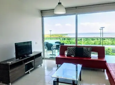 a living room with a red couch and a flat screen tv at Morros 922 una alcoba Edificio frente al mar in Cartagena de Indias