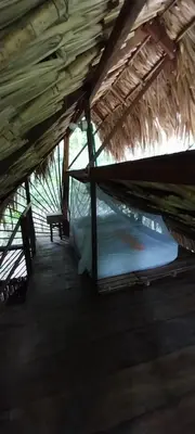 a room with two bunk beds in a straw roof at Eco-Camping Mango Feliz Rincón del Mar in San Onofre