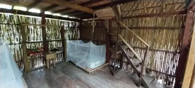 an inside view of a thatched building with a staircase at Eco-Camping Mango Feliz Rincón del Mar in San Onofre