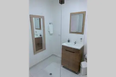 a white bathroom with a sink and a mirror at Apartamento cerca de playas y zonas turísticas in Cartagena de Indias