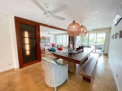 a living room with a wooden table and chairs at Casa de Playa in Cartagena de Indias