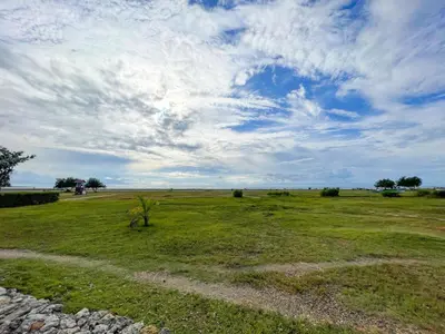 a field of grass with a cloudy sky at Casa de Playa in Cartagena de Indias