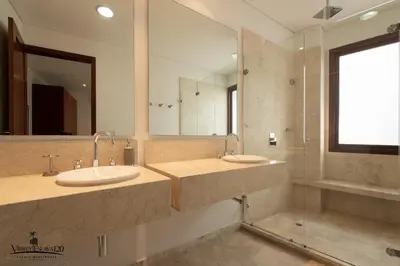 a bathroom with two sinks and a large mirror at Virrey Eslava 120 Luxury Guesthouse in Cartagena de Indias