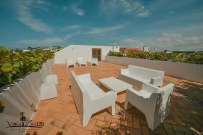 a group of white chairs and tables on a roof at Virrey Eslava 120 Luxury Guesthouse in Cartagena de Indias