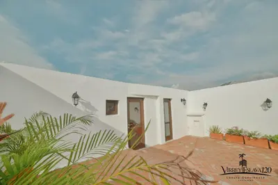 a white house with a brick walkway at Virrey Eslava 120 Luxury Guesthouse in Cartagena de Indias