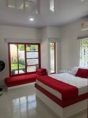a bedroom with a large bed and a window at Bahia Tropical Sandia Kiwi Piña in Coveñas