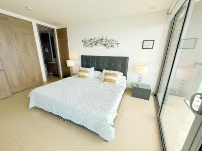 a bedroom with a large bed and two lamps at 31st Perfect Seaview Bocagrande Morros City in Cartagena de Indias