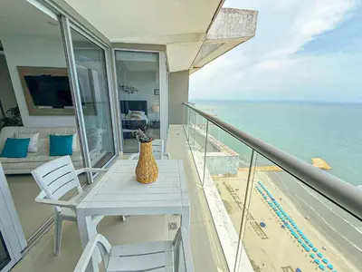 a vase on a table on a balcony with the ocean at 31st Perfect Seaview Bocagrande Morros City in Cartagena de Indias