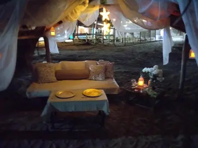 a living room with a couch under a tent at Hotel Portobello in Coveñas