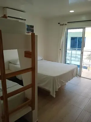 a bedroom with a bunk bed and a balcony at Hotel Portobello in Coveñas