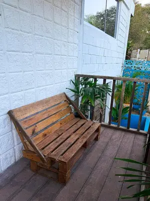 a wooden bench sitting on a wooden deck at PALOMAR EcoCabaña in Santa Veronica