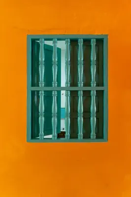 a window on an orange wall with a blue at Casa Renacer in Cartagena de Indias