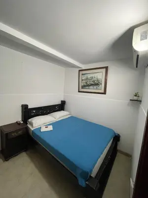a bedroom with a blue bed in a room at Hotel Mangata in Cartagena de Indias