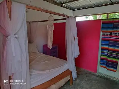a bedroom with a bed with a canopy at Los Versos de Zaira in San Onofre