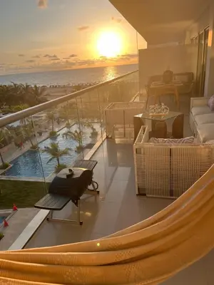 a balcony with a hammock and a view of the ocean at MORROS EPIC luxury beach in Cartagena de Indias